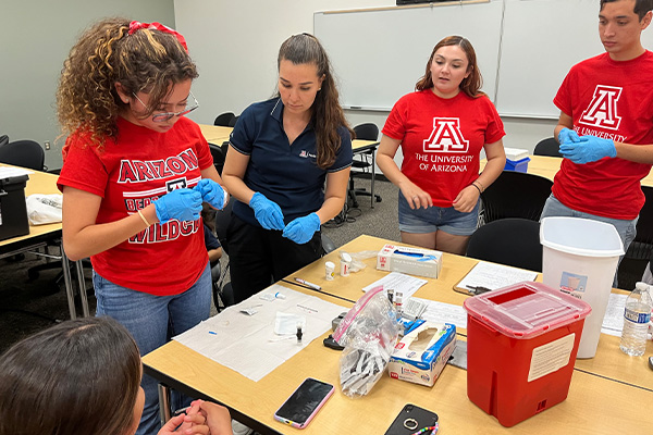 Students learning to draw blood samples