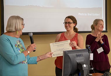 Kathryn Tucker (center) accepts the award for first place in the Community Engagement category.