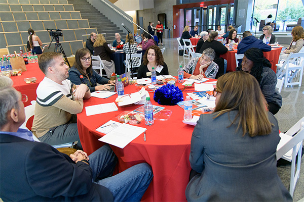 Table exchanging perspectives and suggestions in response to the discussion questions